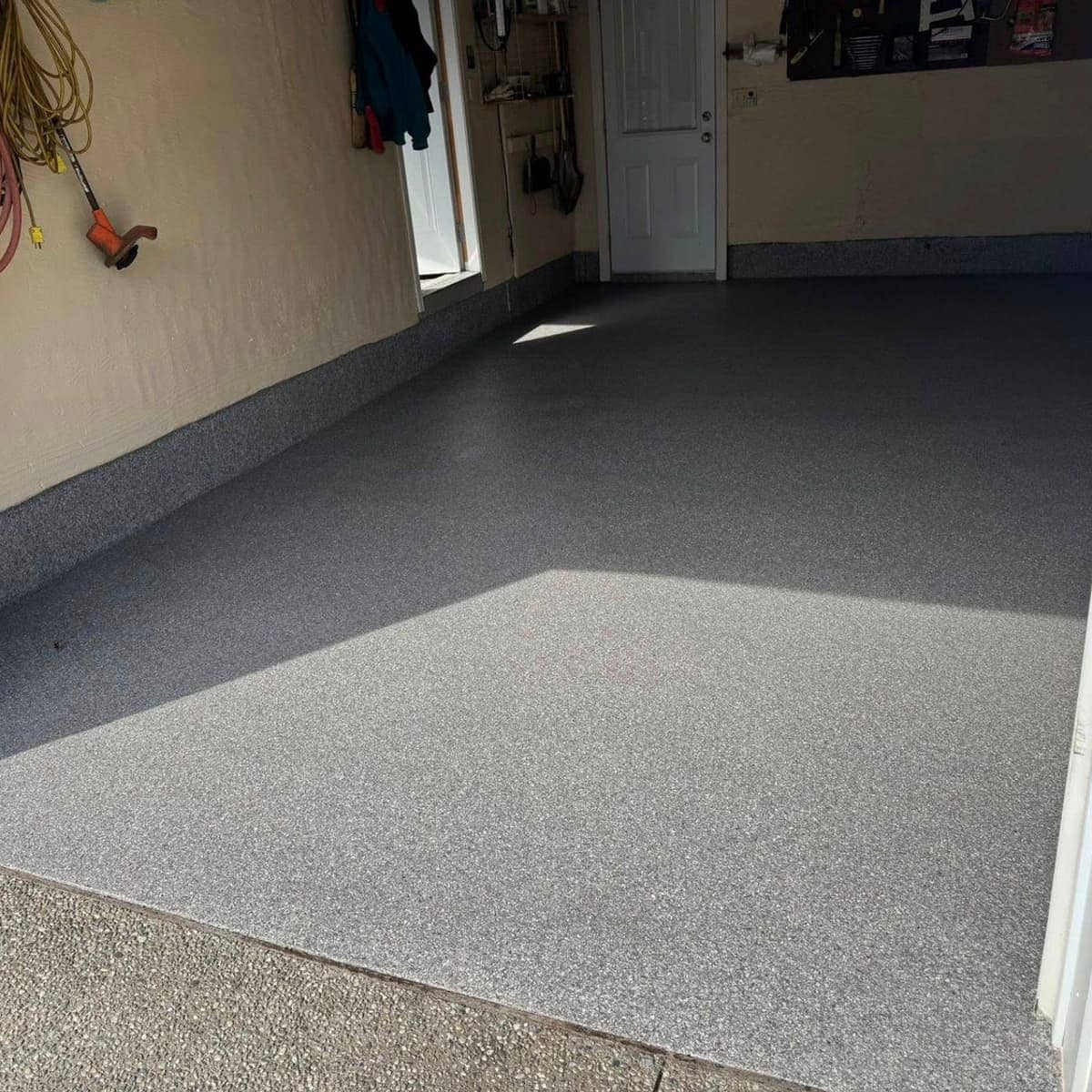 Finished high-gloss grey flake epoxy garage floor by Epoxy Bros