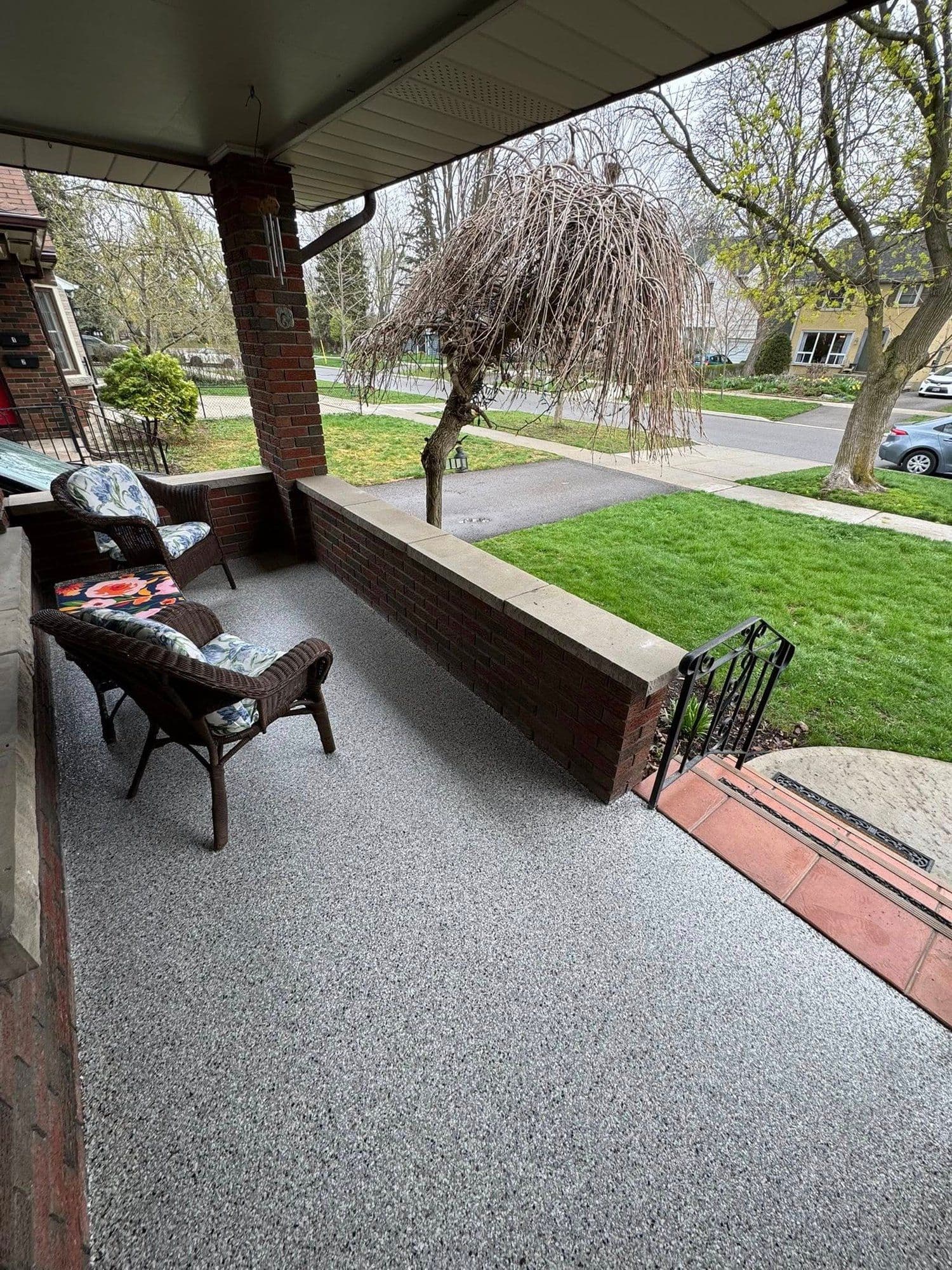 Grey flake epoxy coating on a covered front porch by Epoxy Bros